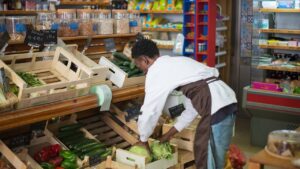 Retail employee stocking shelves at grocery store