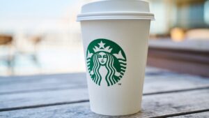 Starbucks cup with brand logo to show importance of protecting brand reputation with background checks