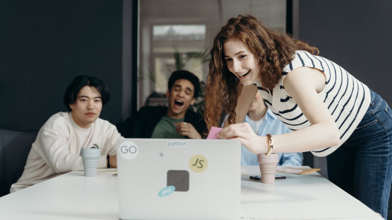 Remote employee joining meeting on laptop to show ultimate guide to hiring remote employees