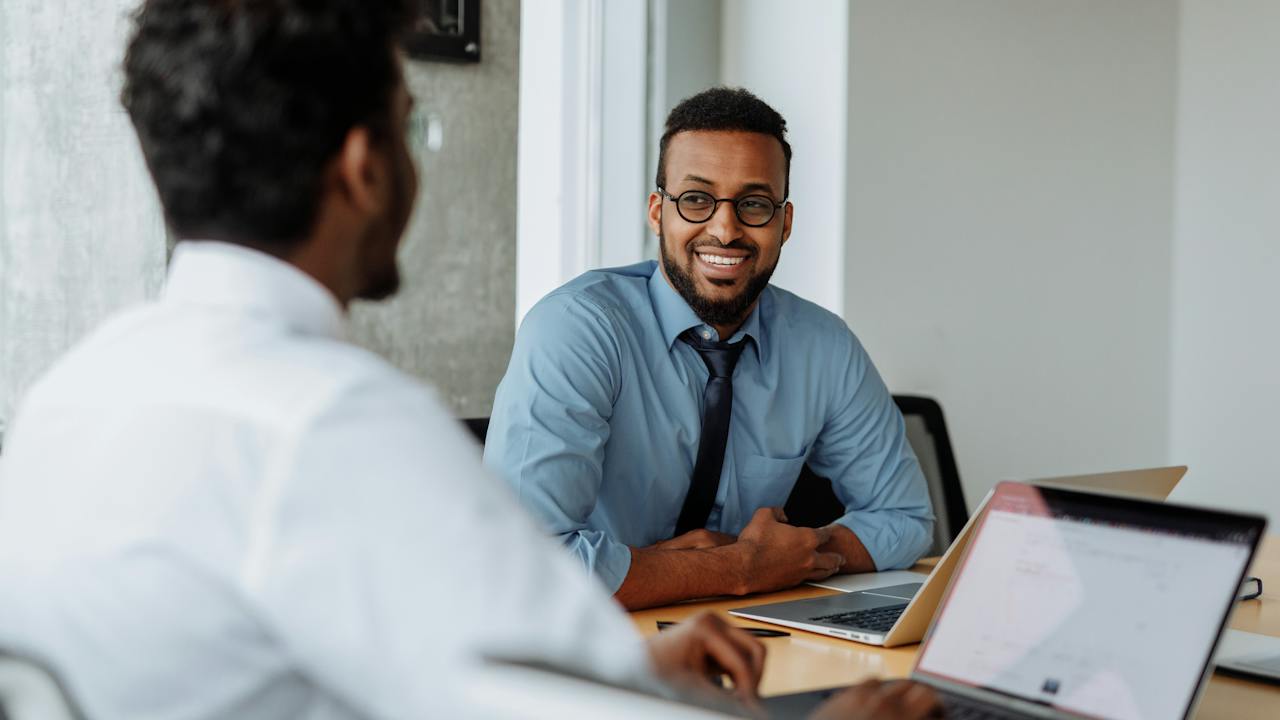 Happy HR hiring managers showing how to increase efficiency and reduce time-to-hire with online background checks