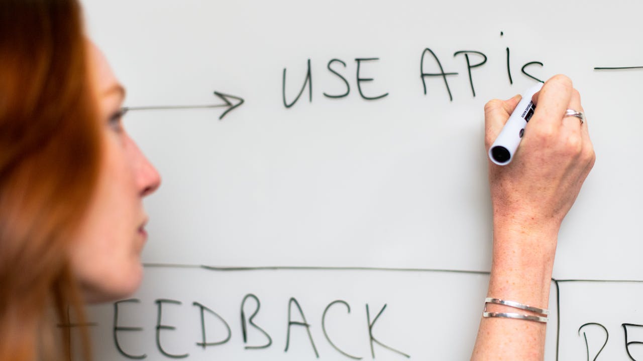 Woman explaining background check API with diagram