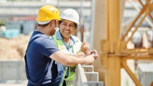 Male and female labourers on construction site depicting hiring for skilled trades and labour