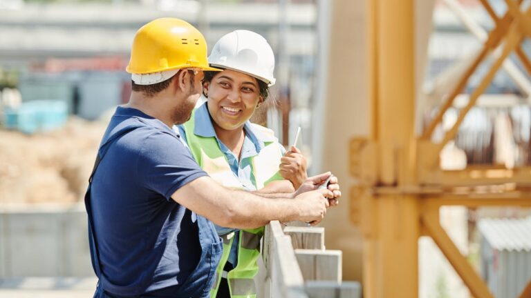 Male and female labourers on construction site depicting hiring for skilled trades and labour