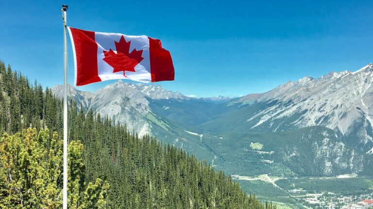 Canadian flag on mountain to represent criminal record checks Canada FAQs