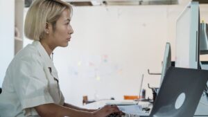 Woman working in IT showing importance of SOC 2 background checks