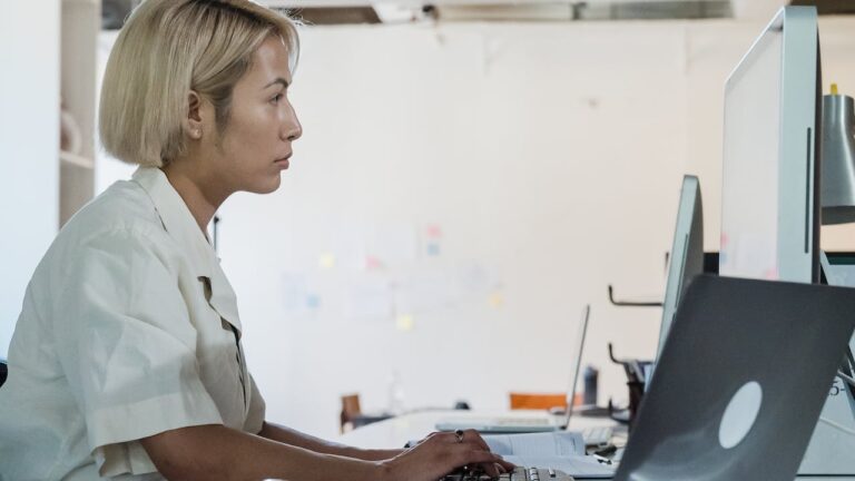 Woman working in IT showing importance of SOC 2 background checks