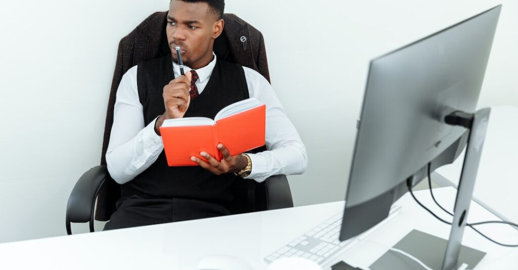 Employer at desk wondering about adverse action notice FAQs