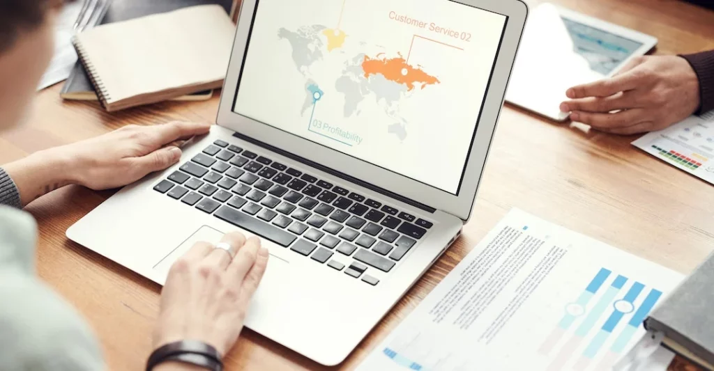 Global team collaborating on remote work on laptop thanks to Certn background check process