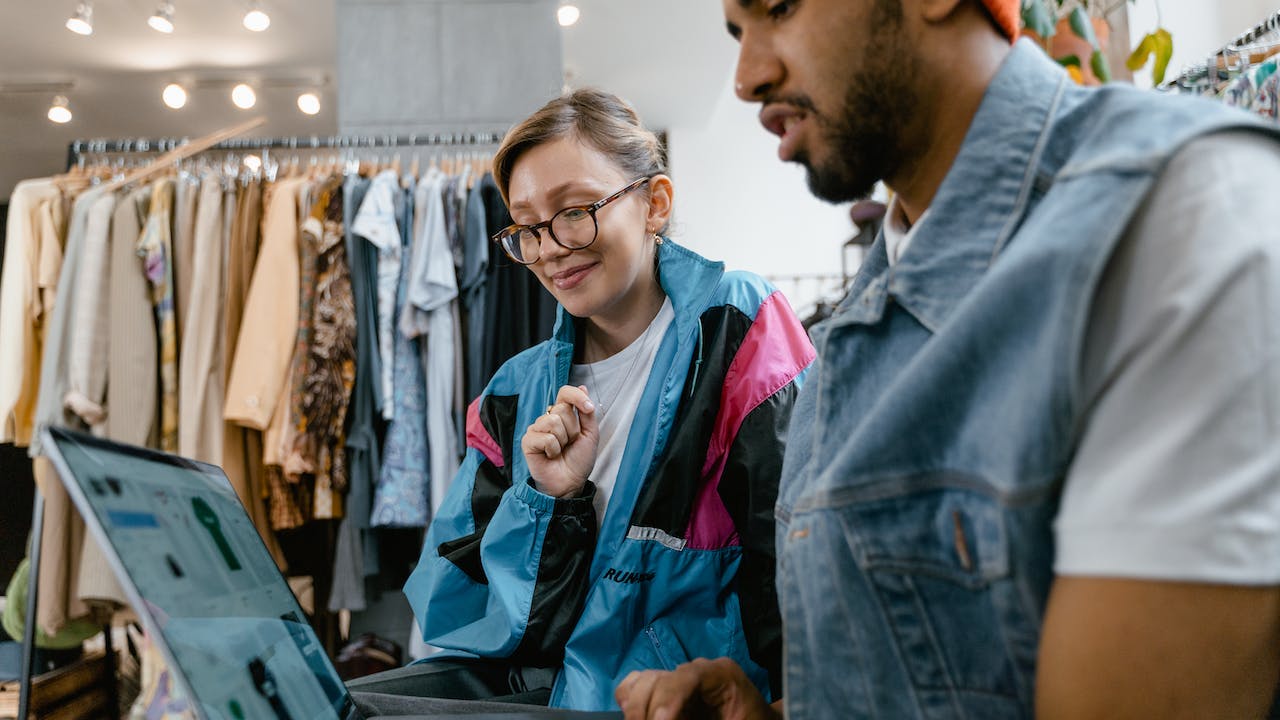 Trusted clothing store employee at cash register representing how to recruit retail employees