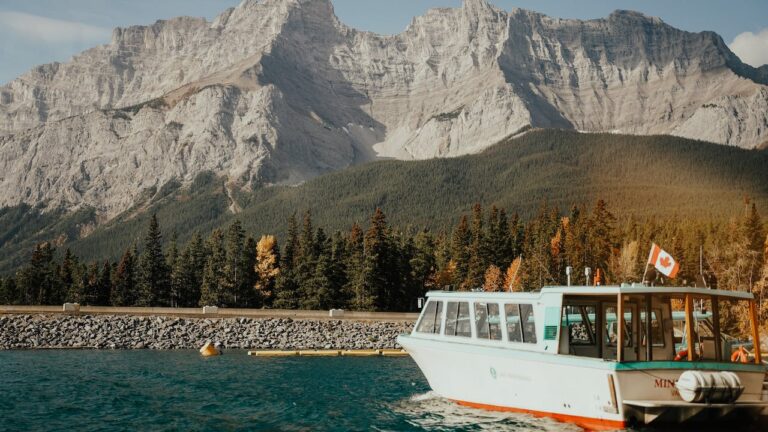 Alberta cruise boat with mountains in background depicting working in Alberta with a criminal record check