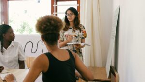 Diverse Coworkers Collaborating in Meeting in Safe Environment Due to Background Checks