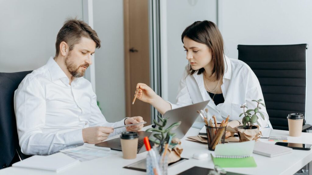 Male and Female Co-Workers Collaborating in Safe Workplace After Backgeround Checks