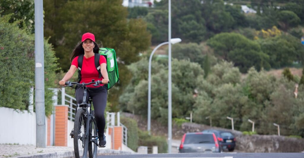 Food delivery gig worker on bike working safely due to background check