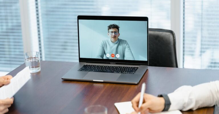 Candidate using tips for addressing a criminal record in a job interview over laptop virtual interview in conference room