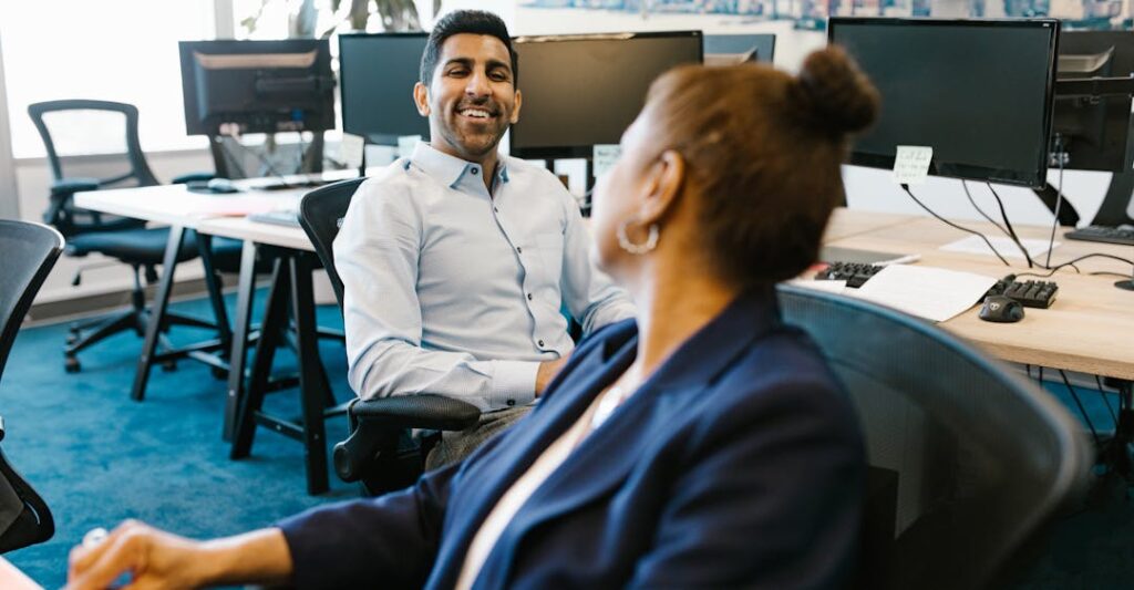 Colleagues collaborating at desk in a safe and relaxed setting thanks to employment background checks and employee screening