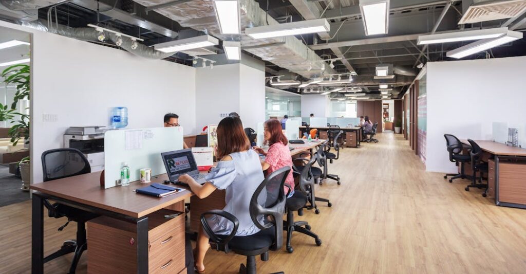 Coworkers in an open concept work environment depicting the best background checks for staffing agencies