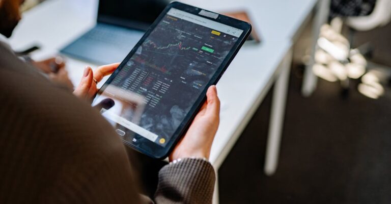 Financial services employees looking at trade information on iPad with a PEP to protect business and investments