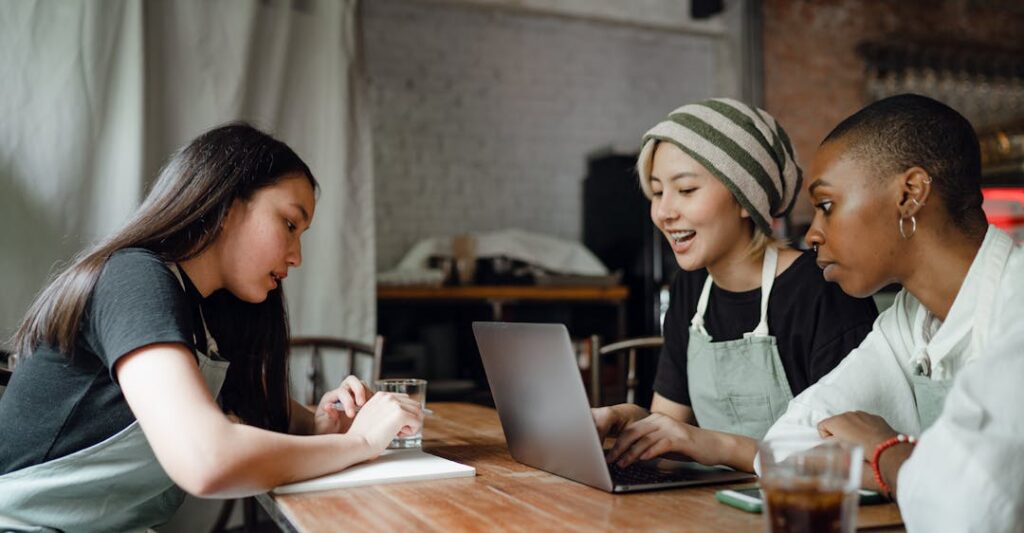Happy employees collaborating around table using tips for addressing a criminal record in an interview