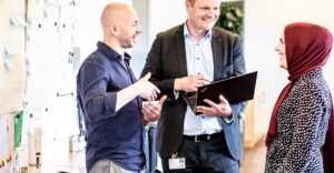 Diverse colleagues collaborating in office to represent global hiring mindset