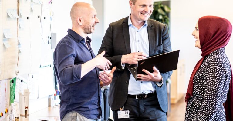 Diverse colleagues collaborating in office to represent global hiring mindset