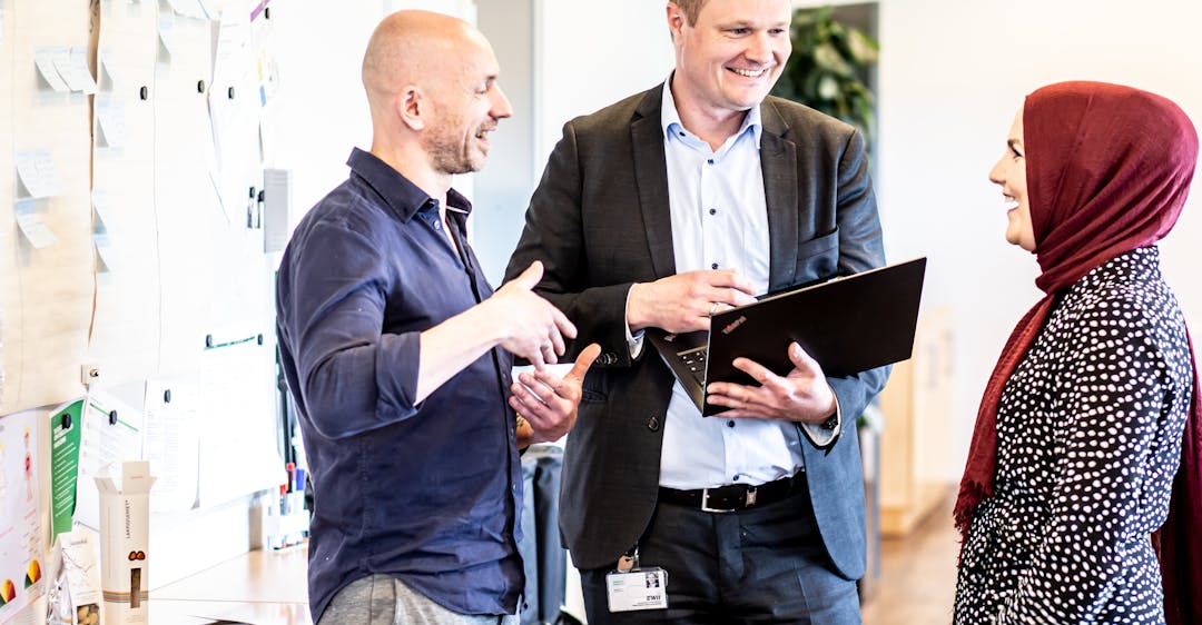 Diverse colleagues collaborating in office to represent global hiring mindset