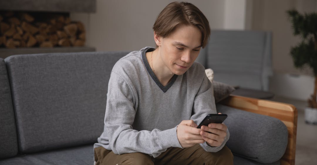 Man taking selfie for remote ID verification for customer onboarding.jpg
