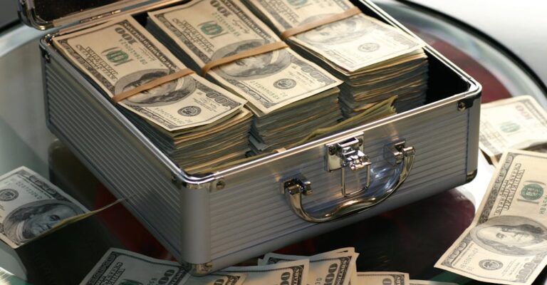 Silver briefcase full of cash to represent money laundering