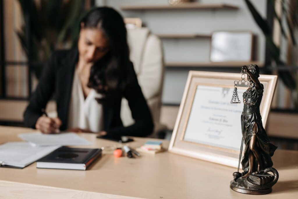 Female lawyer working at desk with diploma displayed representing employment verification pre-employment background checks