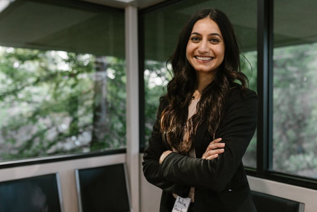 HR Recruiter in Crossed Arms Standing Near the Glass Windows