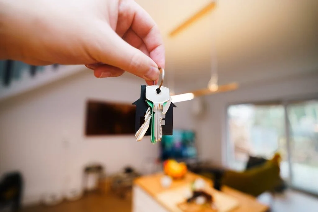 A hand holding keys to rental property after successful background checks
