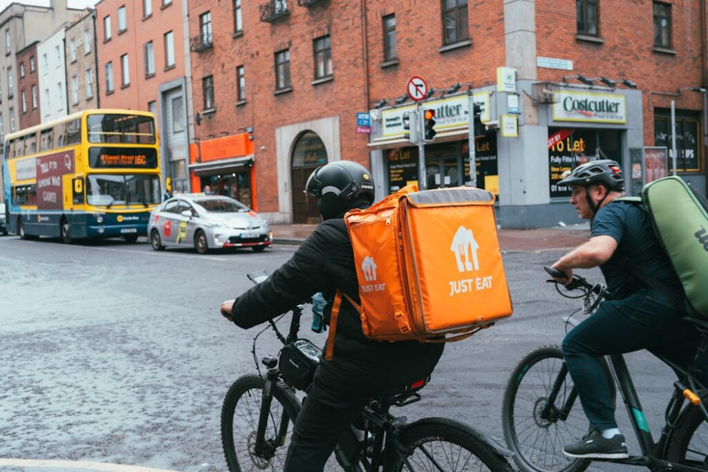 Glasgow City, Scotland, United Kingdom Just Eat delivery driver on bike vetted with new Right to Work checks